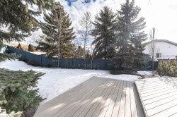 Snow covered deck with a fenced backyard - 