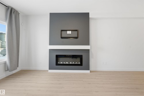 317 Juniper Cove, Leduc, AB - Indoor Photo Showing Living Room With Fireplace