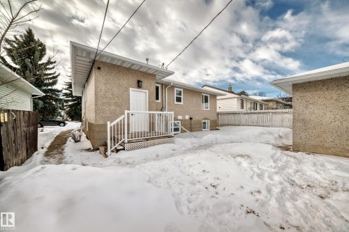 Snow covered property with a wooden deck - 8712 89 Avenue, Edmonton, AB - Outdoor With Exterior