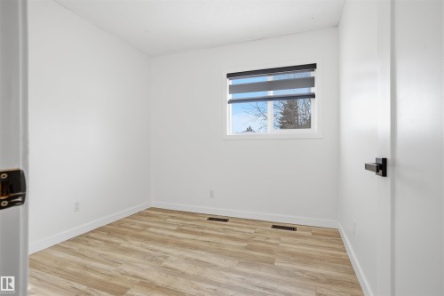 Empty room featuring light wood-type flooring and baseboards - 4204 41B Street, Leduc, AB - Indoor Photo Showing Other Room