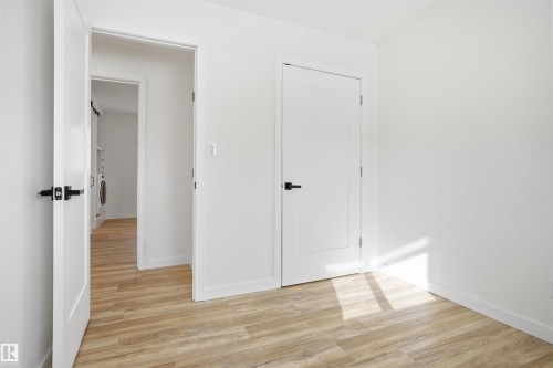 Unfurnished bedroom featuring light wood-style flooring and a closet - 4204 41B Street, Leduc, AB - Indoor Photo Showing Other Room