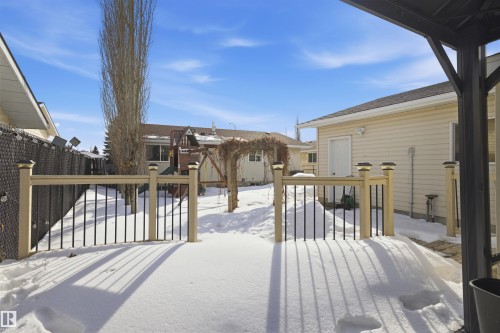Snow covered deck with a residential view - 4204 41B Street, Leduc, AB - Outdoor With Exterior
