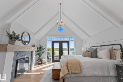 1020 Genesis Lake Boulevard, Stony Plain, AB - Indoor Photo Showing Bedroom With Fireplace