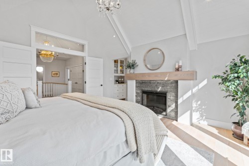 1020 Genesis Lake Boulevard, Stony Plain, AB - Indoor Photo Showing Bedroom With Fireplace
