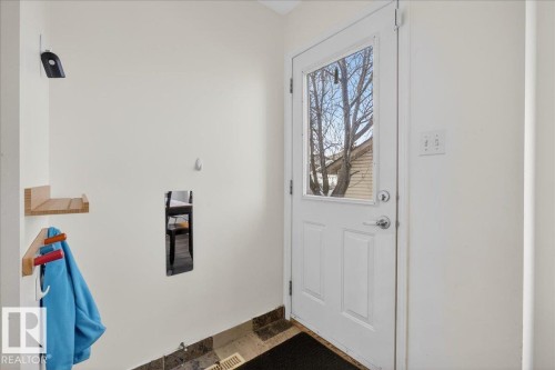 Doorway featuring stone finish flooring and baseboards - 4519 Turner Square Square, Edmonton, AB - Indoor Photo Showing Other Room