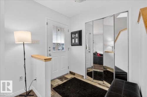Entryway featuring baseboards and light stone finish flooring - 4519 Turner Square Square, Edmonton, AB - Indoor Photo Showing Other Room