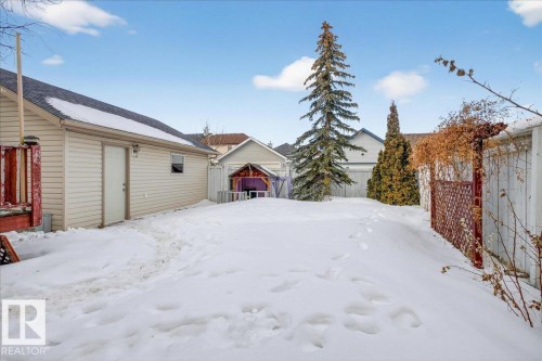 Yard layered in snow with a fenced backyard and an outbuilding - 4519 Turner Square Square, Edmonton, AB - Outdoor