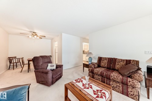 Living room featuring light carpet and ceiling fan - 118 6220 Fulton Road, Edmonton, AB - Indoor Photo Showing Living Room