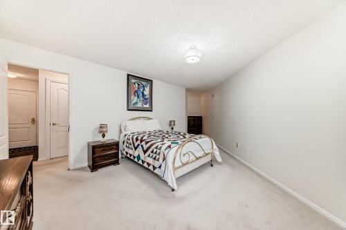 Bedroom featuring light colored carpet and a textured ceiling - 118 6220 Fulton Road, Edmonton, AB - Indoor Photo Showing Bedroom
