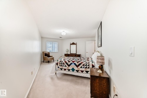 Bedroom featuring light carpet and baseboards - 118 6220 Fulton Road, Edmonton, AB - Indoor Photo Showing Bedroom