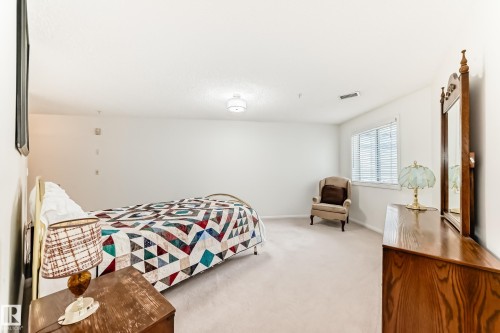 Bedroom featuring light colored carpet and baseboards - 118 6220 Fulton Road, Edmonton, AB - Indoor Photo Showing Bedroom