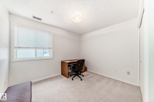 Office area featuring light carpet and a textured ceiling - 118 6220 Fulton Road, Edmonton, AB - Indoor