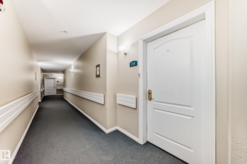 Hall with dark carpet - 118 6220 Fulton Road, Edmonton, AB - Indoor Photo Showing Other Room