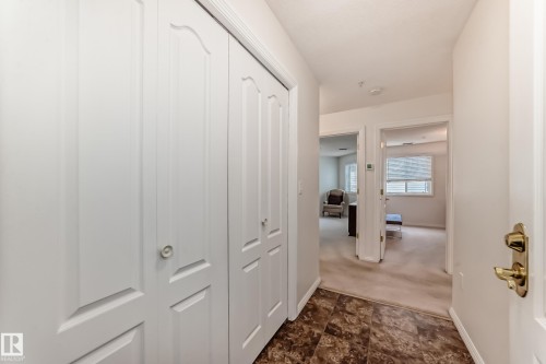 Corridor with stone finish flooring and dark colored carpet - 118 6220 Fulton Road, Edmonton, AB - Indoor Photo Showing Other Room