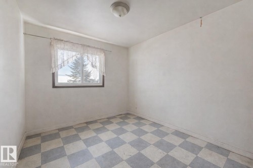 Empty room with light flooring and baseboards - 5219 51 Avenue, Wetaskiwin, AB - Indoor Photo Showing Other Room