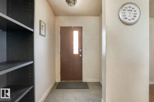 Foyer with baseboards - 5219 51 Avenue, Wetaskiwin, AB - Indoor Photo Showing Other Room
