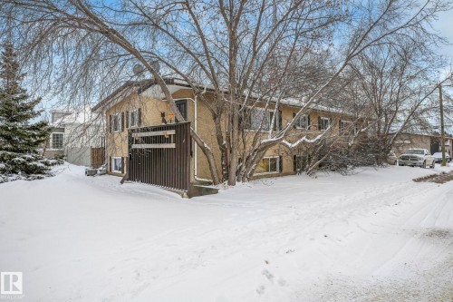 View of front of house with stucco siding and a balcony - 5219 51 Avenue, Wetaskiwin, AB - Outdoor