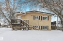Snow covered rear of property featuring stucco siding and a deck - 5219 51 Avenue, Wetaskiwin, AB  - Outdoor 