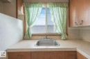 Kitchen with light countertops and wood finish cabinetry - 5219 51 Avenue, Wetaskiwin, AB  - Indoor Photo Showing Kitchen 