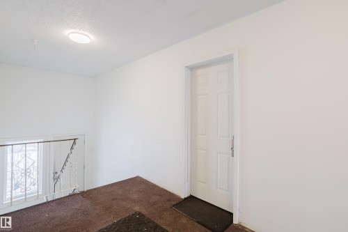 Carpeted empty room with a textured ceiling - 3917/3919 54 Street, Wetaskiwin, AB - Indoor Photo Showing Other Room