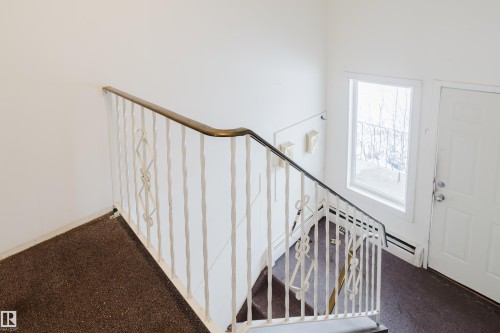 Entrance foyer with carpet floors - 3917/3919 54 Street, Wetaskiwin, AB - Indoor Photo Showing Other Room