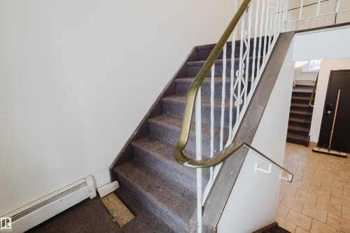 Stairs with baseboard heating - 3917/3919 54 Street, Wetaskiwin, AB - Indoor Photo Showing Other Room