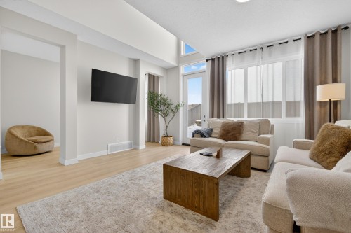 Living room with light wood-style floors and baseboards - 19286 22A Avenue, Edmonton, AB 