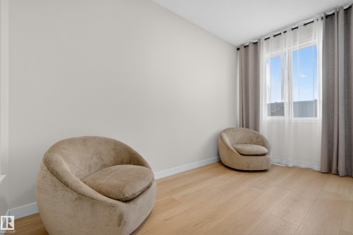Sitting room with light wood-type flooring and baseboards - 19286 22A Avenue, Edmonton, AB 