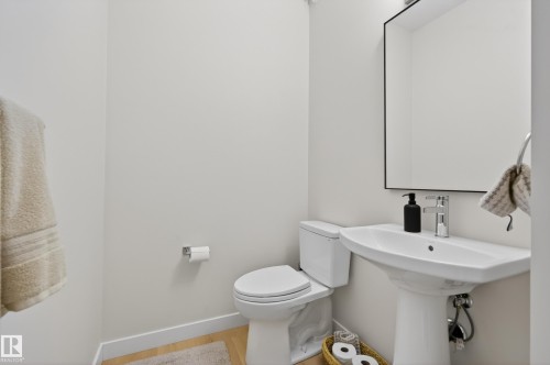 Half bath featuring baseboards and toilet - 19286 22A Avenue, Edmonton, AB 