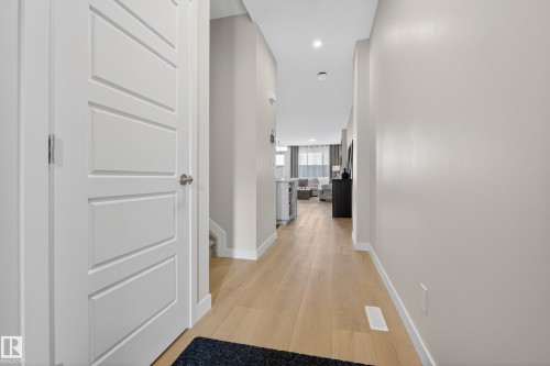 Corridor with light wood finished floors and recessed lighting - 19286 22A Avenue, Edmonton, AB 