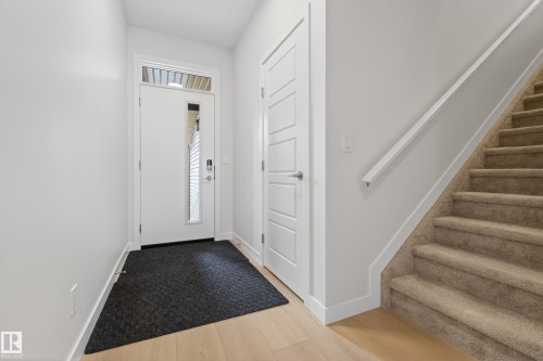 Foyer with stairs and light wood-style floors - 19286 22A Avenue, Edmonton, AB 
