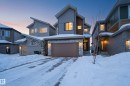 Contemporary house featuring an attached garage, stone siding, and board and batten siding - 19286 22A Avenue, Edmonton, AB 