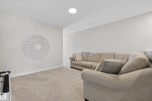 Living area featuring light carpet and baseboards - 19286 22A Avenue, Edmonton, AB 