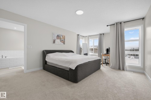 Bedroom featuring light carpet - 19286 22A Avenue, Edmonton, AB 