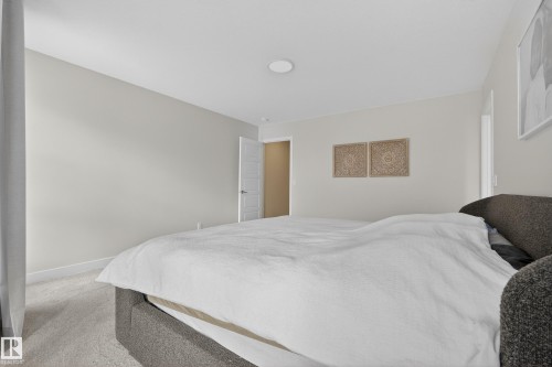 Bedroom with light colored carpet and baseboards - 19286 22A Avenue, Edmonton, AB 