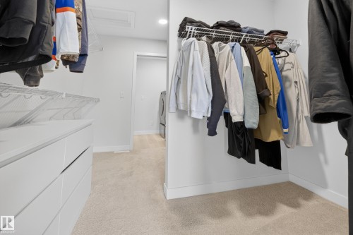 Walk in closet featuring light colored carpet and attic access - 19286 22A Avenue, Edmonton, AB 