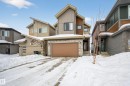 Contemporary house with stone siding, an attached garage, and board and batten siding - 19286 22A Avenue, Edmonton, AB 