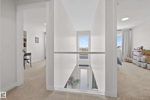 Hall featuring light carpet and recessed lighting - 19286 22A Avenue, Edmonton, AB 