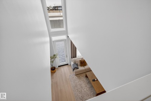 Stairway with wood finished floors, healthy amount of natural light, and a high ceiling - 19286 22A Avenue, Edmonton, AB 