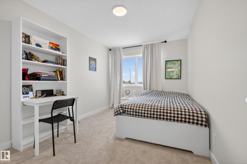Bedroom with light carpet and a textured ceiling - 19286 22A Avenue, Edmonton, AB 
