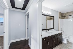 Bathroom with vanity, shower / bath combo, and ornamental molding - 
