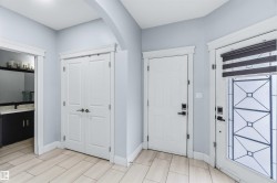 Foyer with baseboards and arched walkways - 