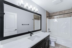 Full bath featuring vanity, a textured ceiling, and washtub / shower combination - 