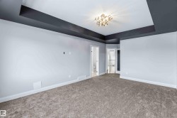 Empty room with a tray ceiling and carpet flooring - 