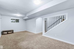 Finished below grade area with a textured ceiling and carpet floors - 