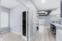 Hall featuring baseboards and a sink - 