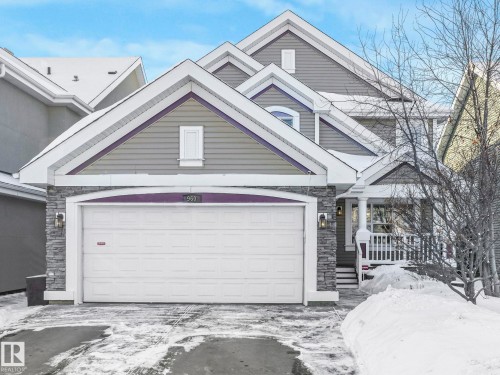 View of front facade with stone siding and driveway - 960 Summerside Link, Edmonton, AB - Outdoor