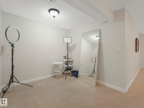 Unfurnished office with a textured ceiling and light carpet - 960 Summerside Link, Edmonton, AB - Indoor
