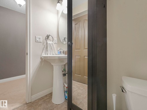 Bathroom with a textured ceiling and light tile patterned floors - 960 Summerside Link, Edmonton, AB - Indoor Photo Showing Bathroom