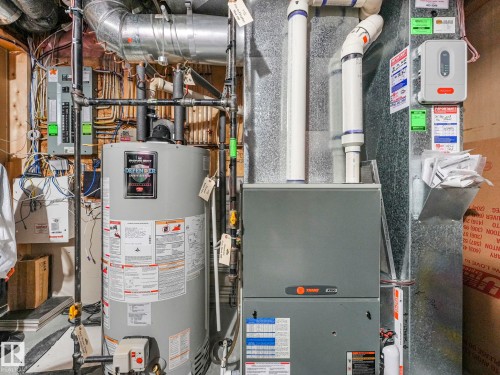 Utilities with gas water heater, electric panel, and heating unit - 960 Summerside Link, Edmonton, AB - Indoor Photo Showing Basement